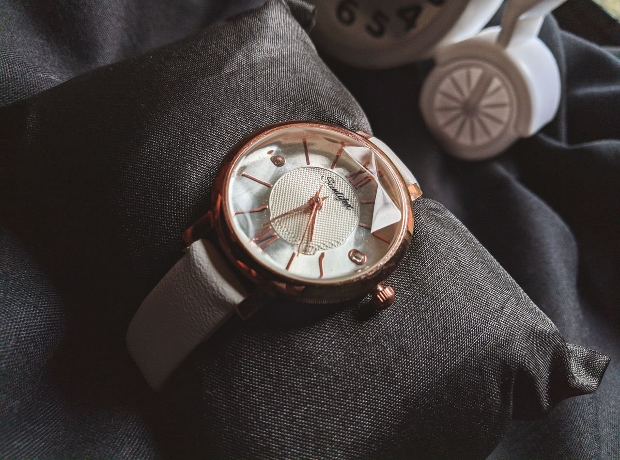 About Close-up of a stylish rose gold wristwatch showcasing luxury and fashion on a black pillow.